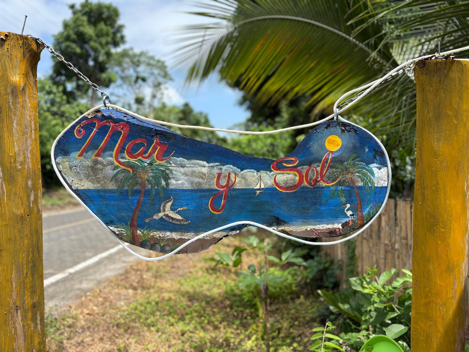 Hand-painted Mar y Sol sign hanging at the entrance